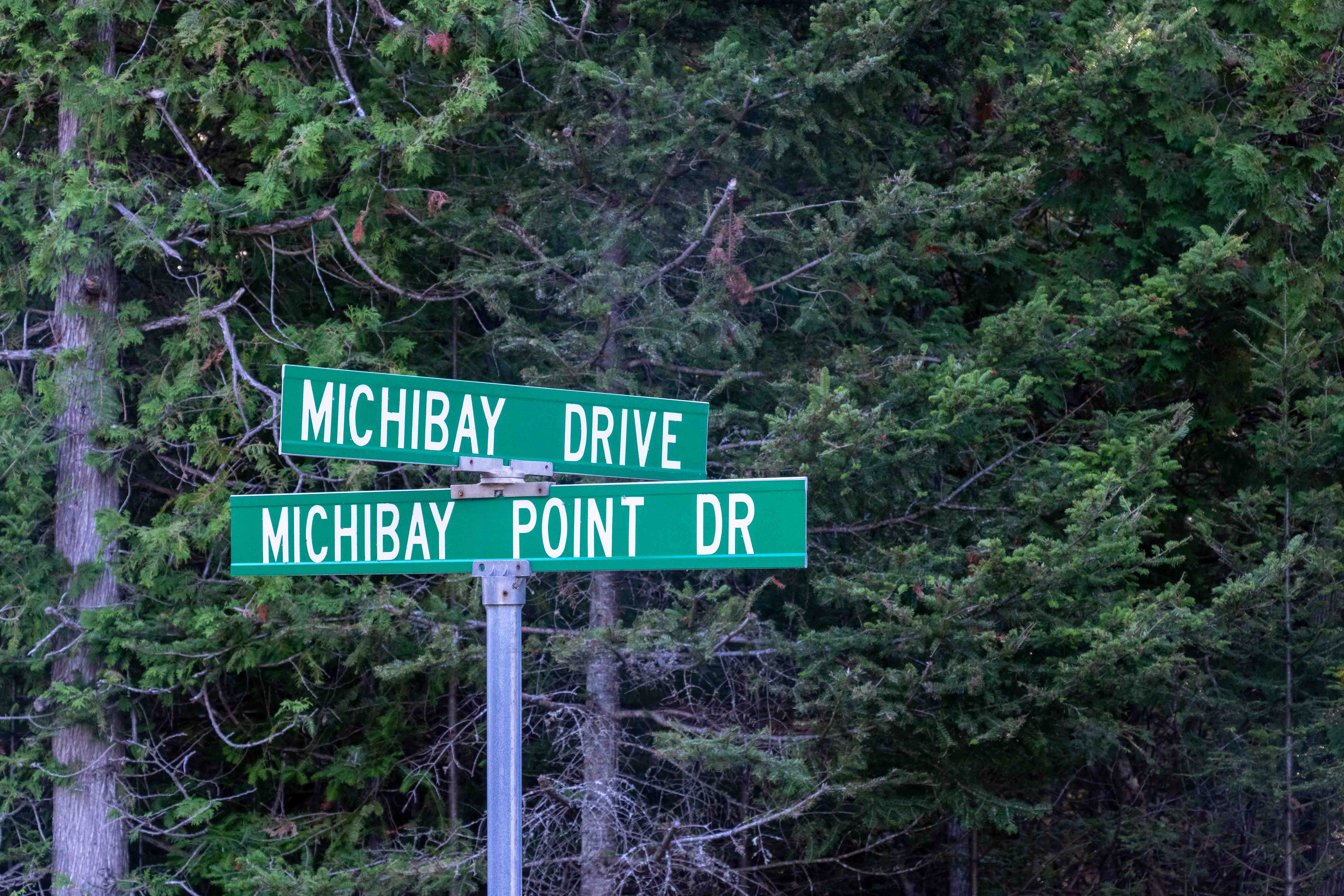 Two Green Cross Road Signs to Michibay Drive and Michibay Point Dr